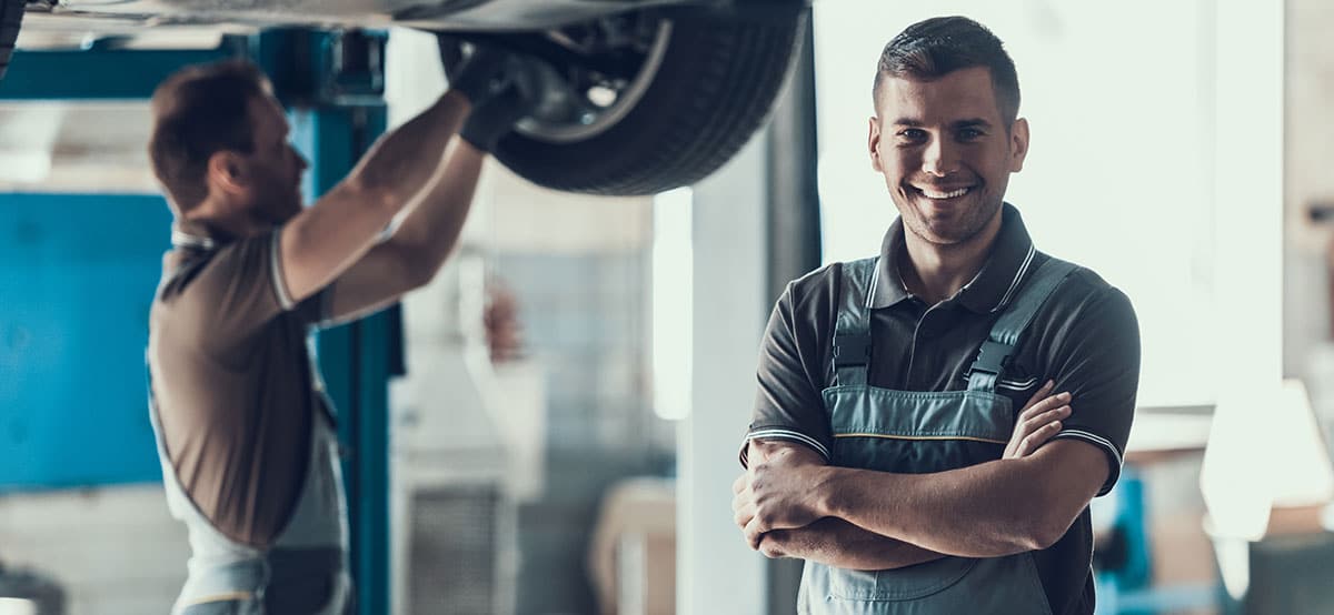 Mechanics checking a wheel bearing